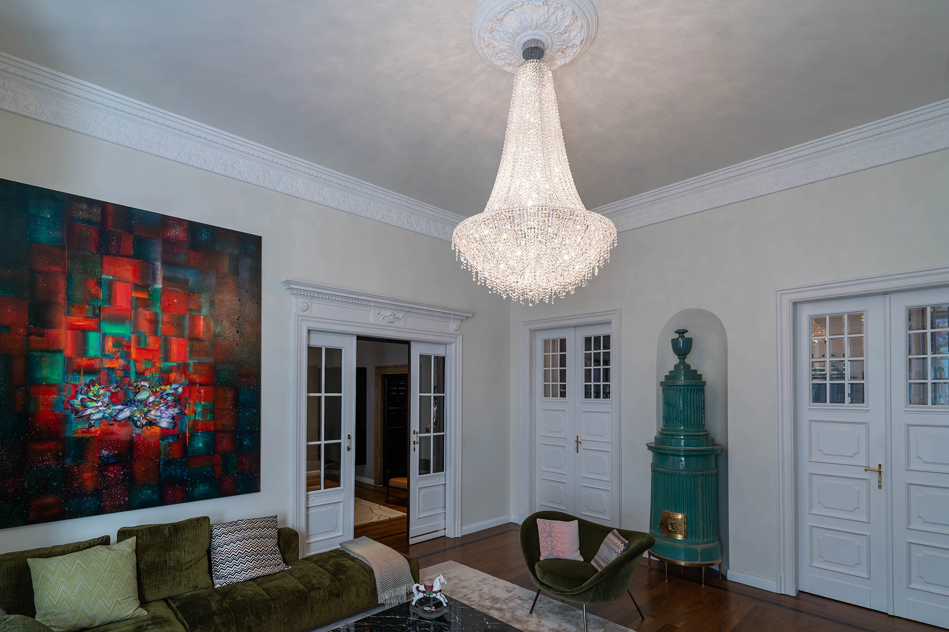 Bespoke crystal chandelier in a neoclassical luxury living room.